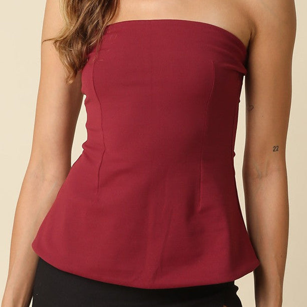 Olivaceous Mika strapless peplum tube top in black, fitted design with ruffle detail, sleeveless and cropped style.